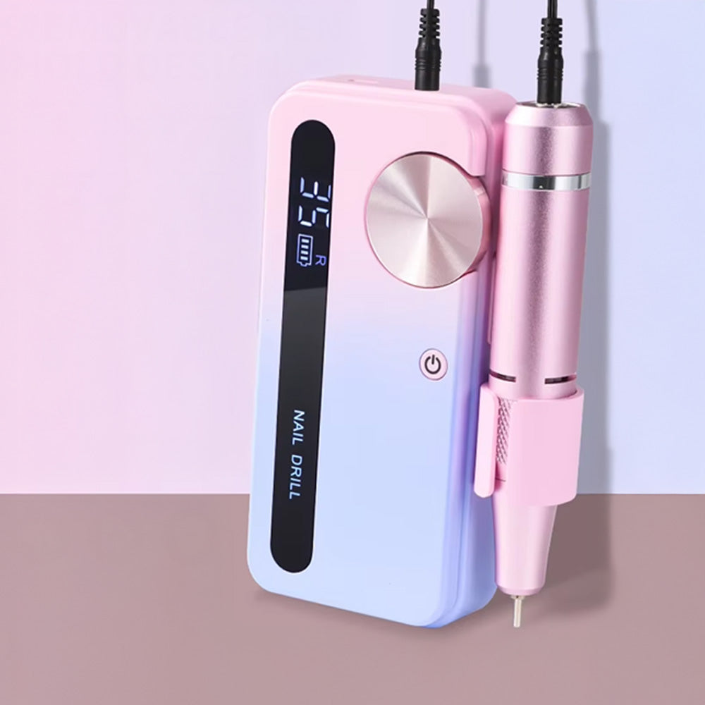Gros plan sur la ponceuse à ongles 35000 RPM en dégradé rose et bleu avec pièce à main fixée sur son support, mettant en avant son design élégant et compact.