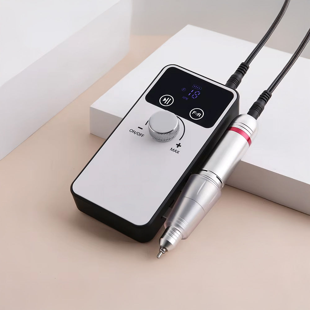 Gros plan de la ponceuse à ongles professionnelle 45000 RPM connectée, avec écran allumé indiquant la vitesse. Design épuré avec boutons de contrôle et pièce à main ergonomique.