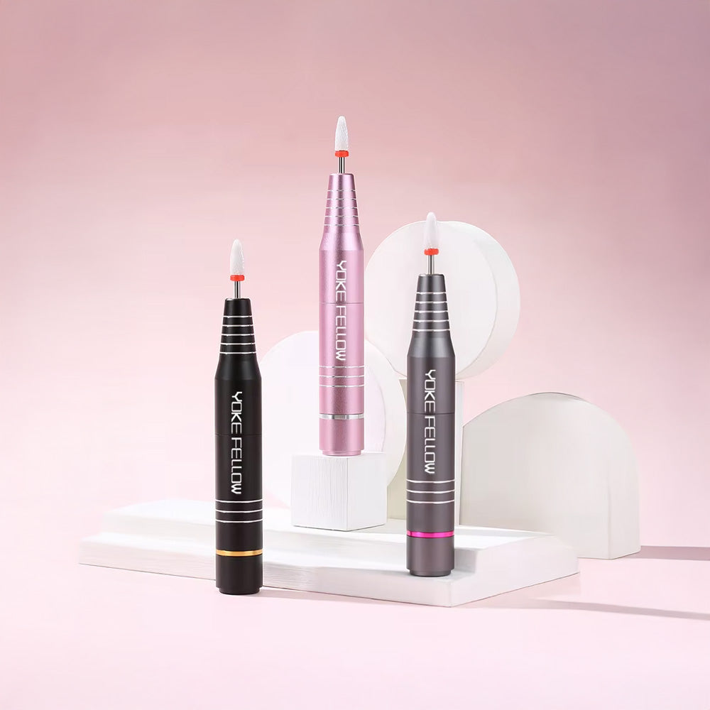 Présentation des trois ponceuses à ongles sans fil 30 000 RPM en différentes couleurs (noir, rose et gris), mises en valeur sur un décor raffiné et minimaliste.